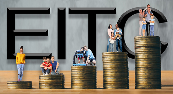 EITC words written in the background with people standing on coins